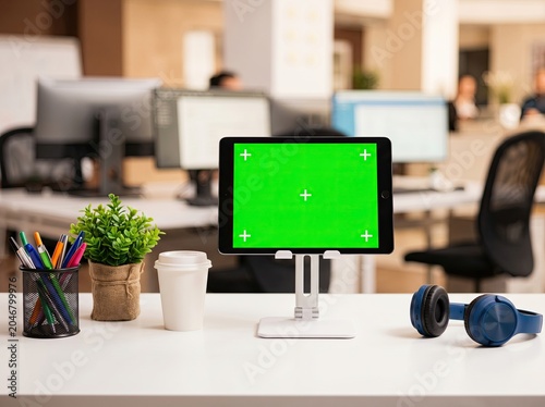 Digital Tablet Mockup with Green Screen on Desk Stand in Modern Corporate Office Workspace Blurred Background