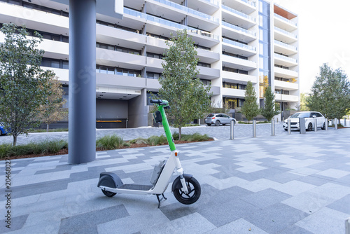 Green Electric Bicycle Parked Near Residential Apartment Complex Sustainable Urban Transport