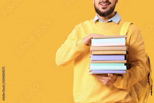 Male student with stack of ...