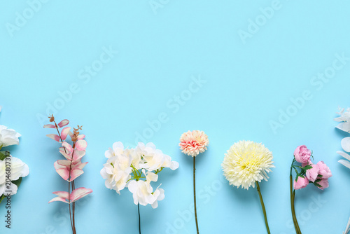 Konstfotografi Beautiful artificial flowers branches on blue background
