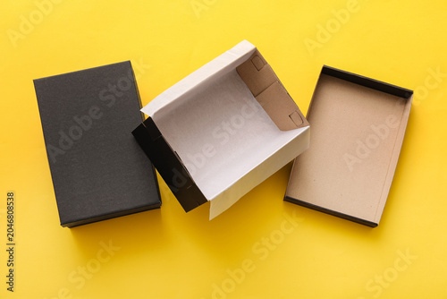 Empty black shoeboxes on ye...