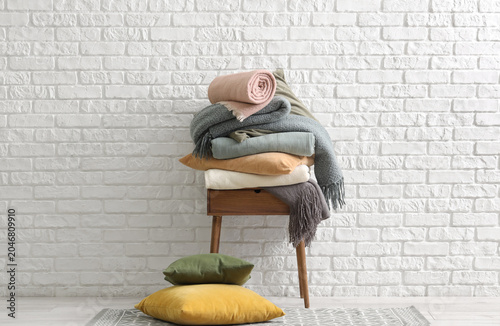 Stack of cozy blankets on t...