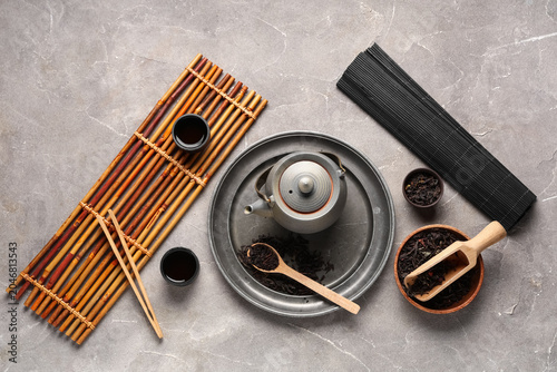 Bamboo mat with teapot, cup...