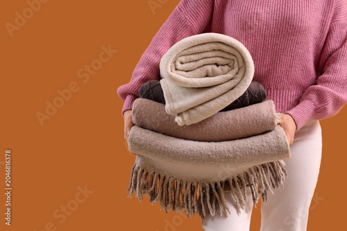 Young woman with stack of s...