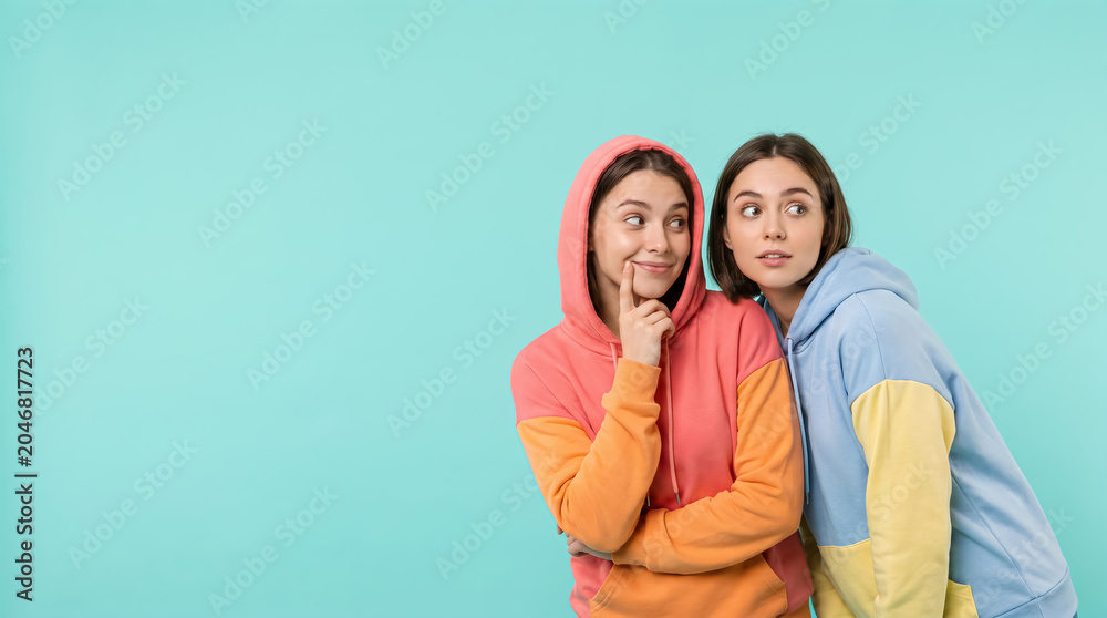 Naklejka premium Playful Lesbian Couple Looking At Copyspace On Turquoise Background