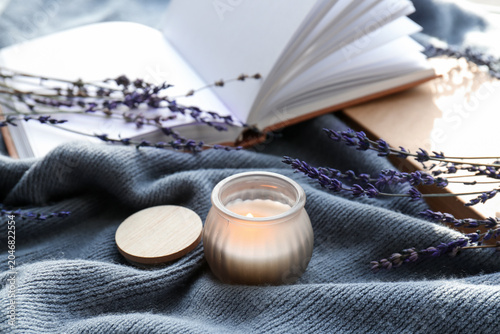 Burning candle, books and l...