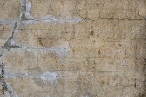 Schilderij op canvas Distressed concrete retaining wall, marked by water run stains, dark damp patches, and a network of fine hairline cracks spreading across the aged, weathered surface