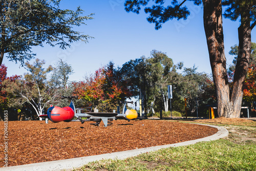 Photography Colorful Playground Seesaw in Park on Sunny Autumn Day - Left Low Angle
