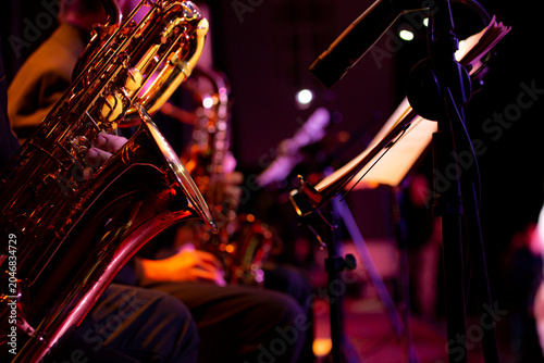 Saxophone close up with dramatic light jazz music concept  copyspace
Close up of a saxophone with dramatic lighting highlighting metallic texture. Music concept representing jazz, 
performance, elegan