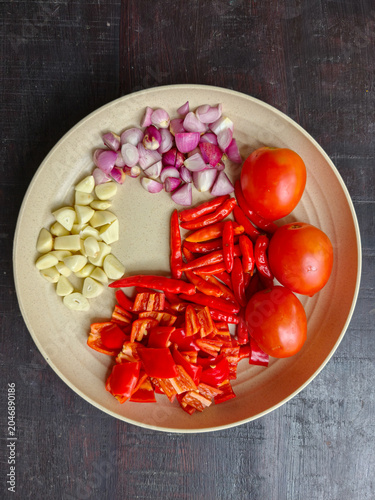 Фотография Chopped Fresh Ingredients with Red Chili, Shallots, Garlic, and Tomatoes on a Pl
