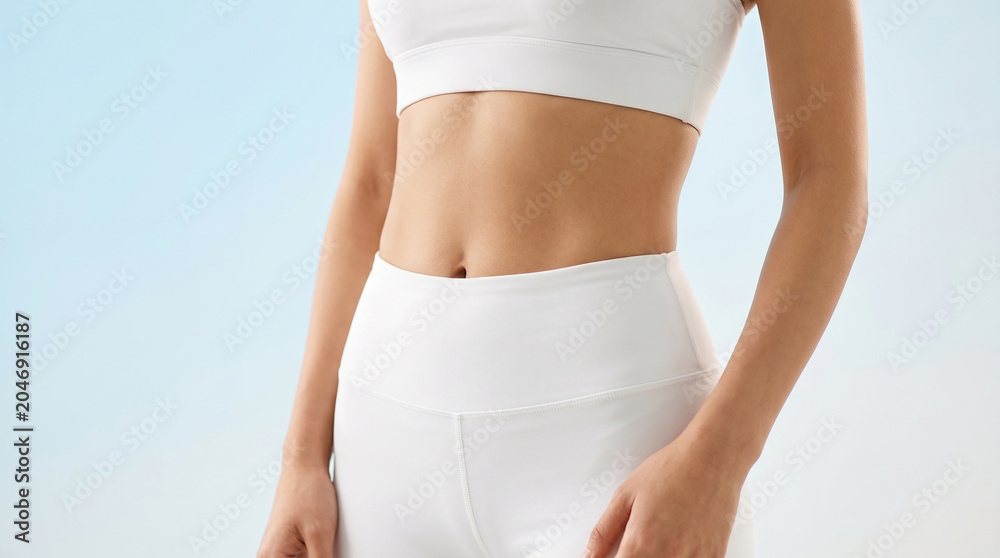 Fototapeta premium Woman's Midsection in White Sportswear