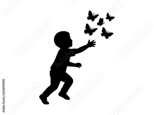 Silhouette of a Young Boy Chasing and Reaching for Flying Butterflies