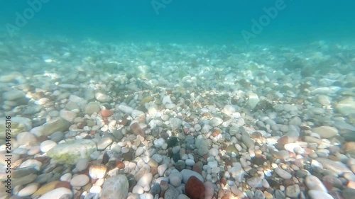 Colorful rocks and sand beneath the sea