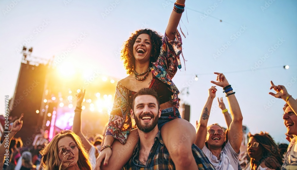 Obraz premium Couple Celebrating at Outdoor Music Festival.