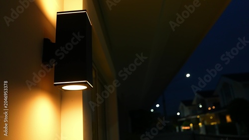 Tableau sur toile Bright lights on at dusk reveal excessive electricity use in homes, highlighting the comfort and convenience embraced by the modern middle class, sometimes beyond real necessity