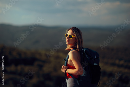 Canvastavla Happy Sporty Woman with Backpack Standing on a Hill