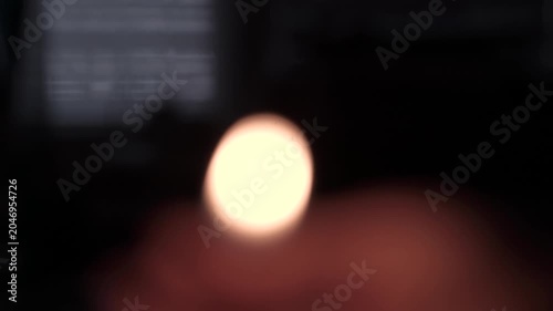 Hand Holding Burning Candle in Dark Close Up