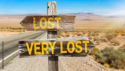 Lost very lost directional wooden signpost in arid desert