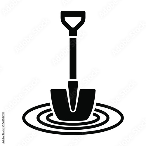 Fotografie Shovel stuck in water with ripples around it symbolizing struggle or challenge