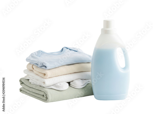Stack of baby clothes with a bottle of laundry detergent isolated on transparent background