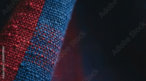 Macro shot of textured woven fabric with red and blue threads