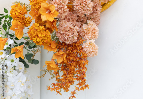Orange and rose-colored flowers on a white background.