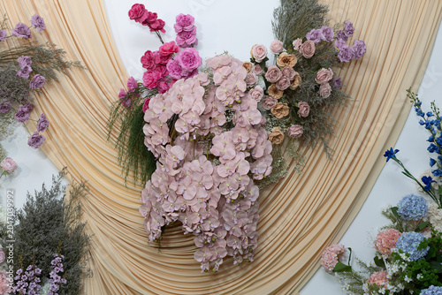 Orange and rose-colored flowers on a white background.