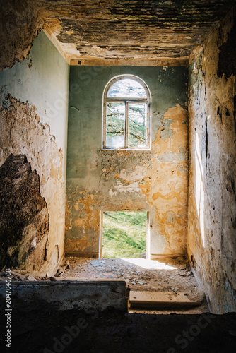 Ruined interior of the abandoned Savane Sanatorium in Tskaltubo, Georgia, where nature slowly reclaims a Soviet-era landmark.