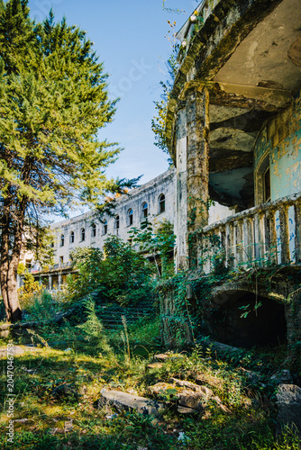 Abandoned Savane Sanatorium in Tskaltubo, Georgia, surrounded by wild vegetation and showcasing decaying Soviet-era architecture.