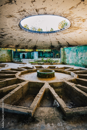 Interior of abandoned Bathhouse #8 in Tskaltubo, Georgia, showcasing a striking skylight and decaying Soviet spa architecture.
