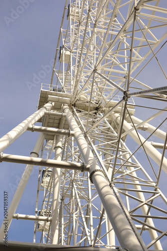 Steel structure of the Ferris wheel. White Ferris wheel.