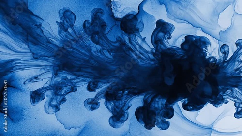 Abstract blue liquid ink swirling and flowing in water background swirl flow cloud dye artistic