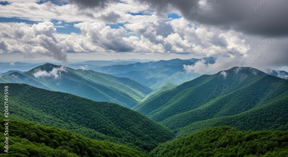 Fototapeta premium Scenic green mountain range with clouds in summer sunlight
