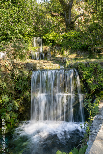 A small cascading waterfall in a small stream.