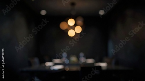 Detail of dark dining room ambiance with glowing golden light spheres