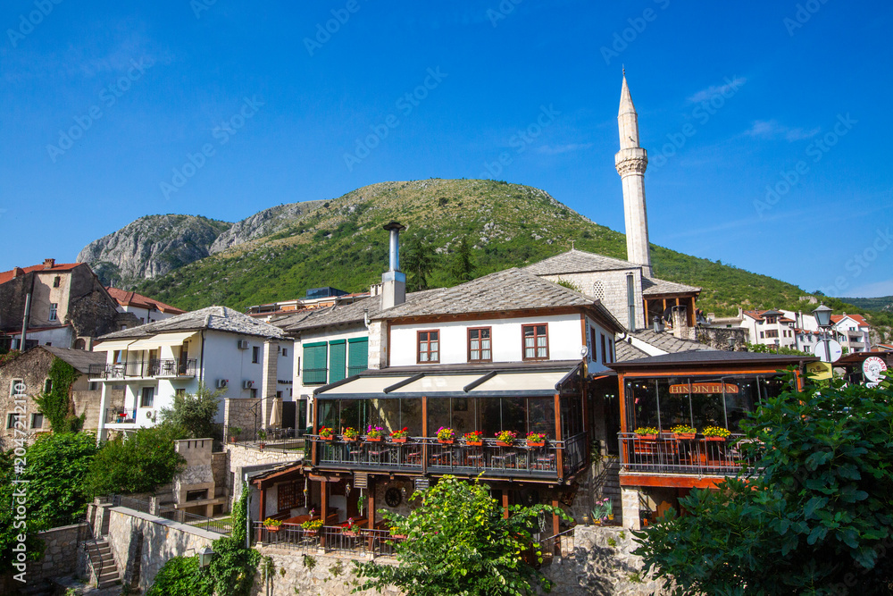 Naklejka premium Historical Nezir Aga mosque and traditional stone houses in old town of Mostar, Bosnia and Herzegovina