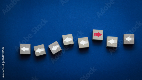 Konstfotografi Leadership and innovation concept with one red arrow moving in the opposite direction among white arrows