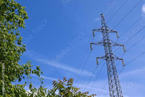 High voltage power lines and tower, symbolizing electricity costs, energy crisis, and cost of living.