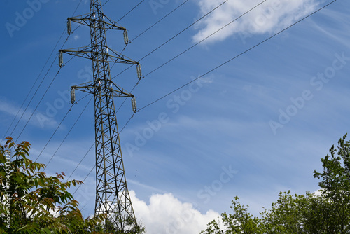 High voltage power lines and tower, symbolizing electricity costs, energy crisis, and cost of living.