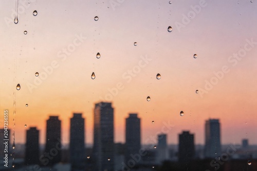 City skyline at sunset with raindrops