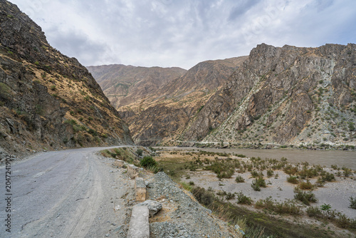 Scenic roadside landscape view of Panj river valley bordering Afghanistan in Darvaz, Gorno-Badakhshan, Tajikistan Pamir	
