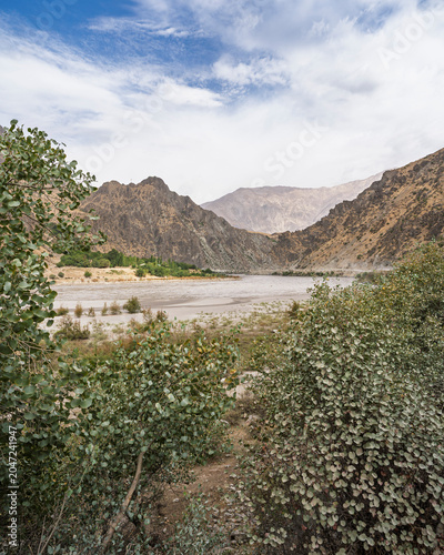 Vertical mountain landscape view of Panj river valley in summer, Darvaz, Gorno-Badakhshan, Tajikistan Pamir