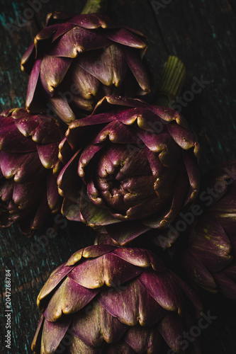 Fresh Purple Artichokes on Rustic Wooden Background