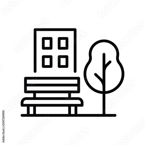 Billede på lærred Public park bench icon situated in front of a modern residential building silhou