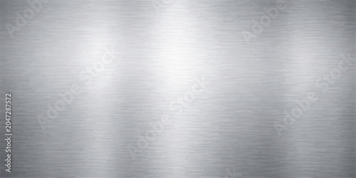 A polished stainless steel plate features a shiny brushed metal texture, creating an industrial silver alloy surface pattern suitable for a metallic background or material wallpaper