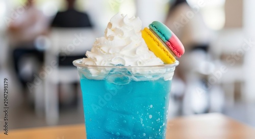 Whimsical Blue Italian Soda Topped with Whipped Cream and a Colorful Macaron