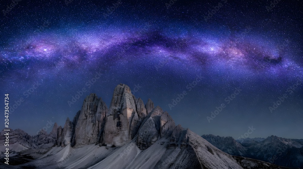 Obraz premium Milky Way galaxy arching over Tre Cime di Lavaredo mountain peaks at night.