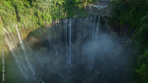 Aerial view of Panorama Tumpak Sewu Waterfalls also known as Coban Sewu.Beautiful rainbow and fog,Tumpak Sewu Waterfalls are a tourist attraction in East Java, Indonesia.Amazing travel destination