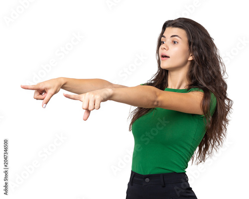 Happy young caucasian female in a shirt pointing fingers away