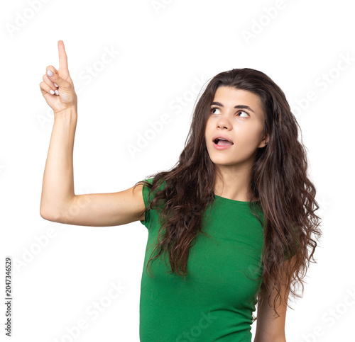 Happy young caucasian female in a shirt pointing fingers away